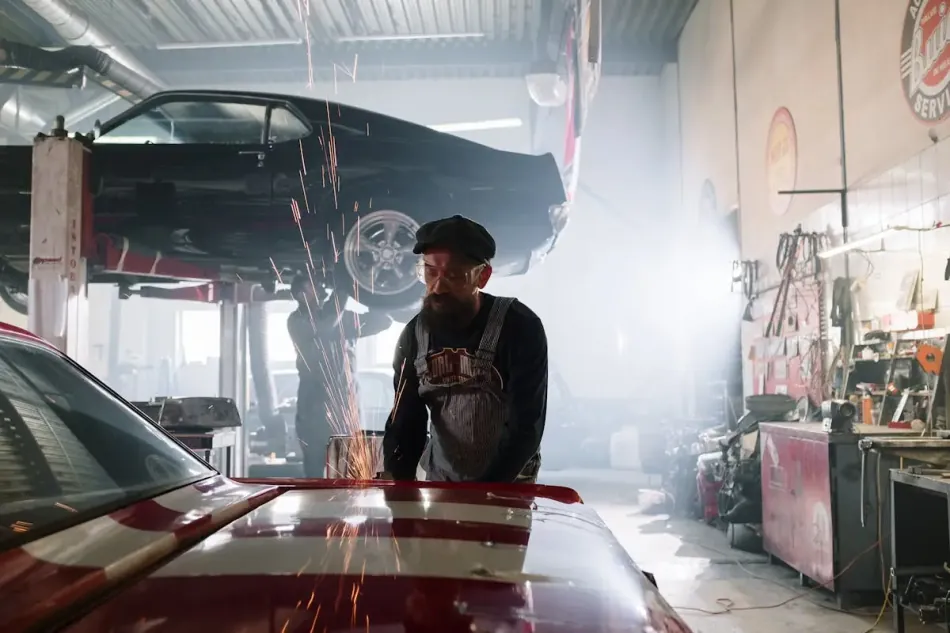 Mechanic inspecting vehicle undercarriage